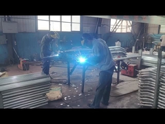 The mesh connection accessories are being welded on the fence post